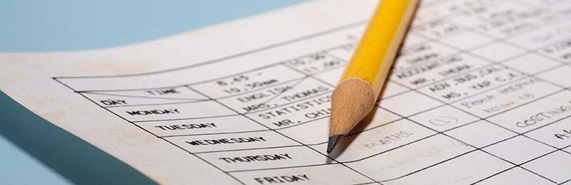 Paper school schedule and pencil